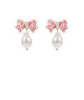 Floral printed enamel bow earrings with faux pearl dangle and titanium post displayed on a white background from The Pink Doxie Boutique.