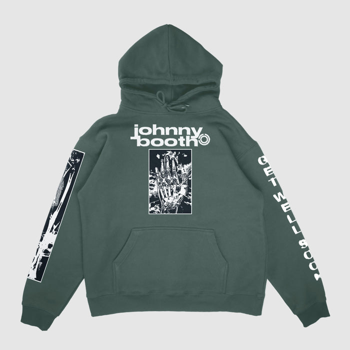 A green Johnny Booth Comfort Colors hoodie featuring “johnny booth” text and a skeletal hand on the front, X-ray bone graphics on one sleeve, and “GET WELL SOON” in white on the other—premium printed garment.