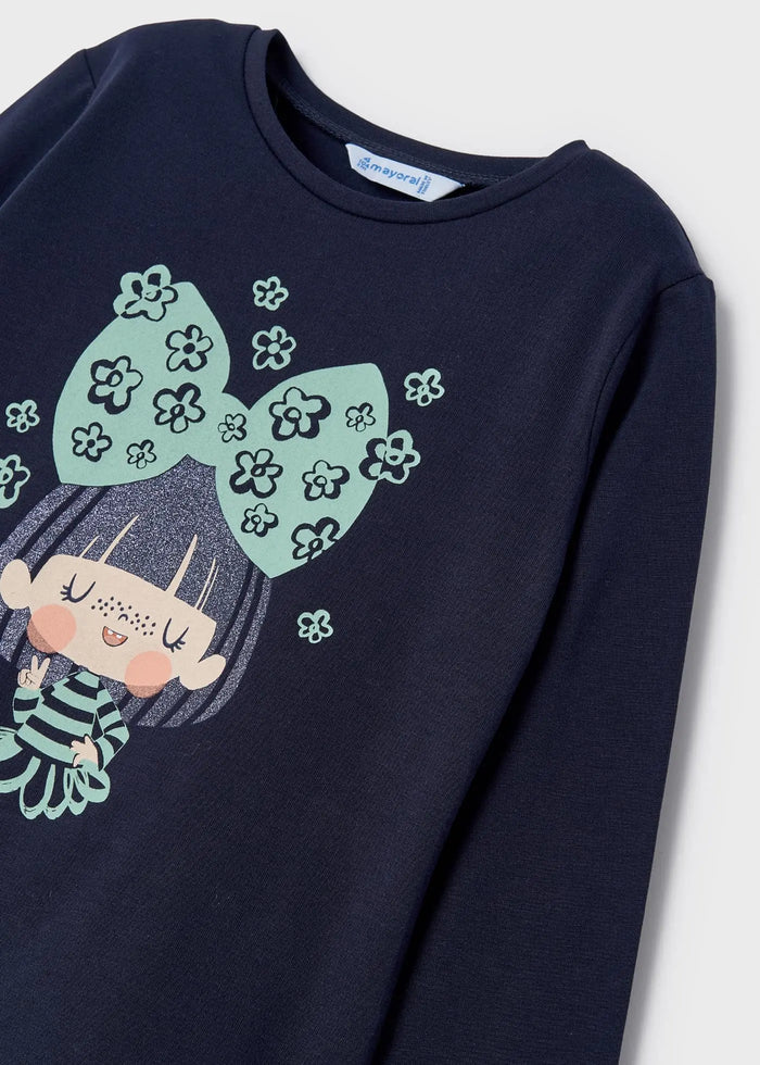 Close-up of mint floral bow and girl graphic on navy Mayoral top