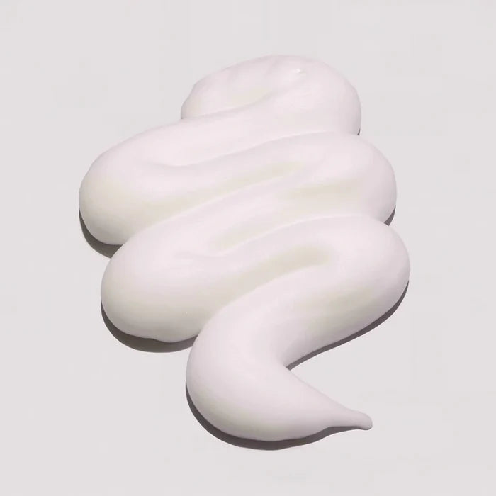 White, creamy swirl on a light gray background milk_shake Lifestyling Volumizing Foam