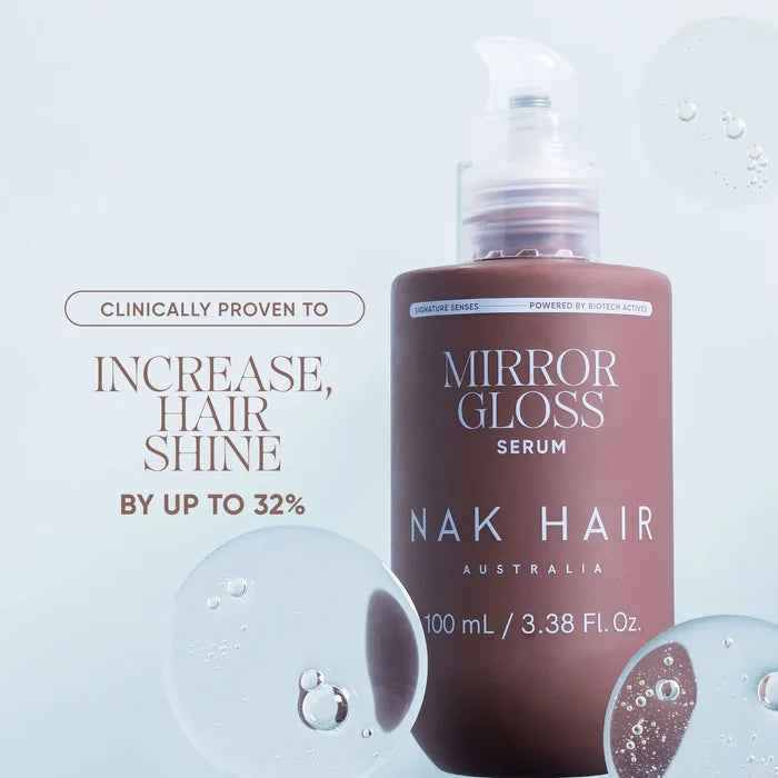 Mirror Gloss Serum for Nak Hair, a 100 mL pump bottle with a frosted cap, set against a light blue background with decorative water droplets and promotional text.