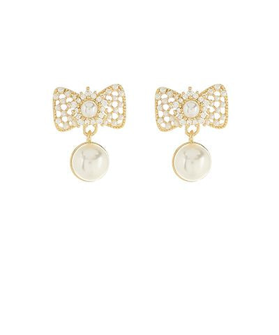 Gold-tone ribbon drop earrings with crystal details and a faux pearl accent displayed on a white background from The Pink Doxie Boutique.