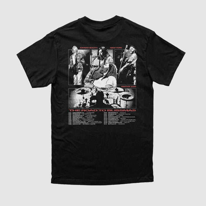 The Johnny Booth black t-shirt, made from Comfort Colors, features a white and red back graphic of four musicians performing with a drum set silhouette and "The Road to Blissmas" above tour dates—ideal for printed apparel fans.