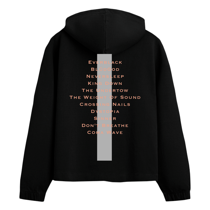 A black hooded sweatshirt by Crystal Lake is shown from the back, featuring a vertical gray stripe and orange song titles down the center—a standout printed apparel piece for music fans.