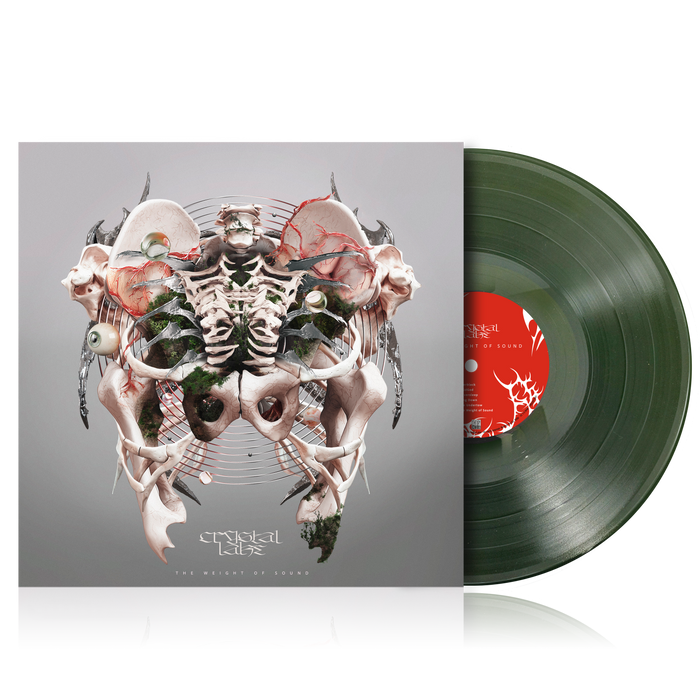 A Crystal Lake vinyl record, partly out of its sleeve, features a symmetrical abstract design with bones, skulls, and organic shapes on a gray cover. The transparent dark green vinyl has a red and white label.
