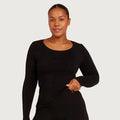 A woman modeling a black long-sleeve scoop-neck top against a light gray studio background.